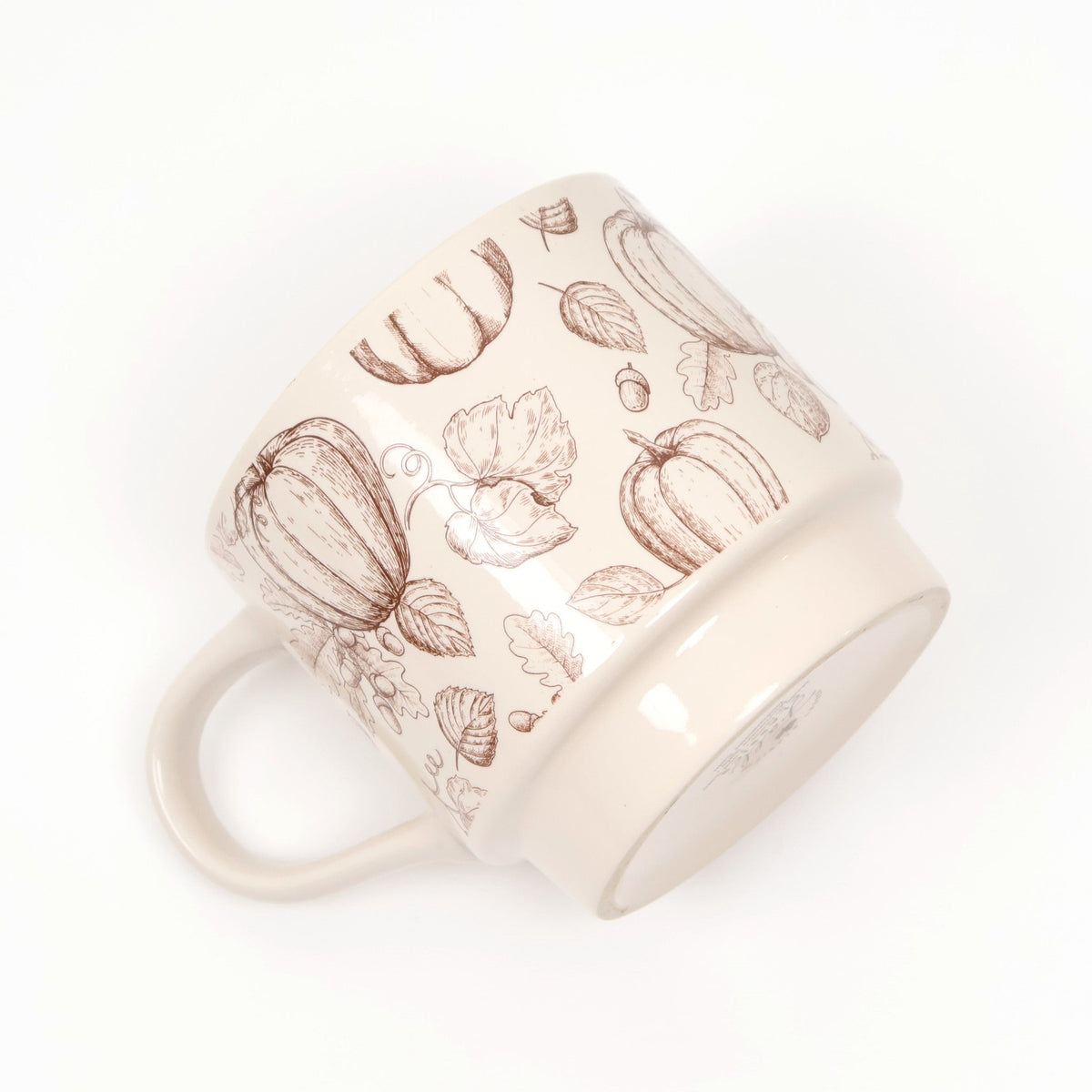 Cream ceramic mug with a brown pumpkin and leaf print