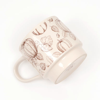 Cream ceramic mug with a brown pumpkin and leaf print