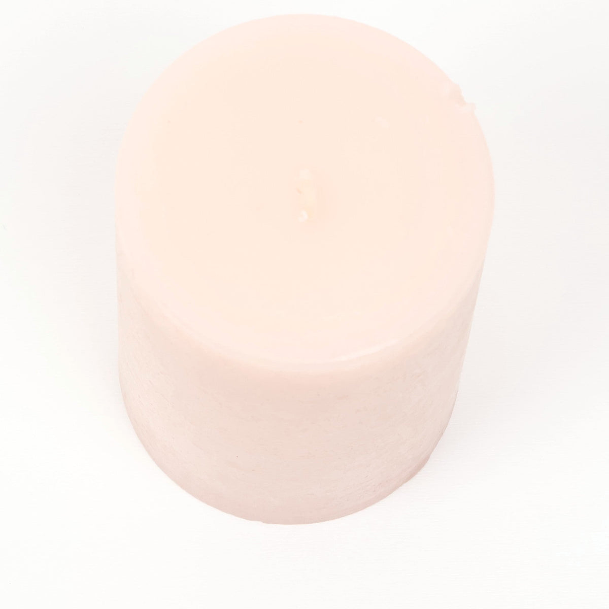 Blush pink pillar candle with a matte finish