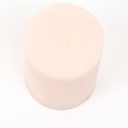 Blush pink pillar candle with a matte finish