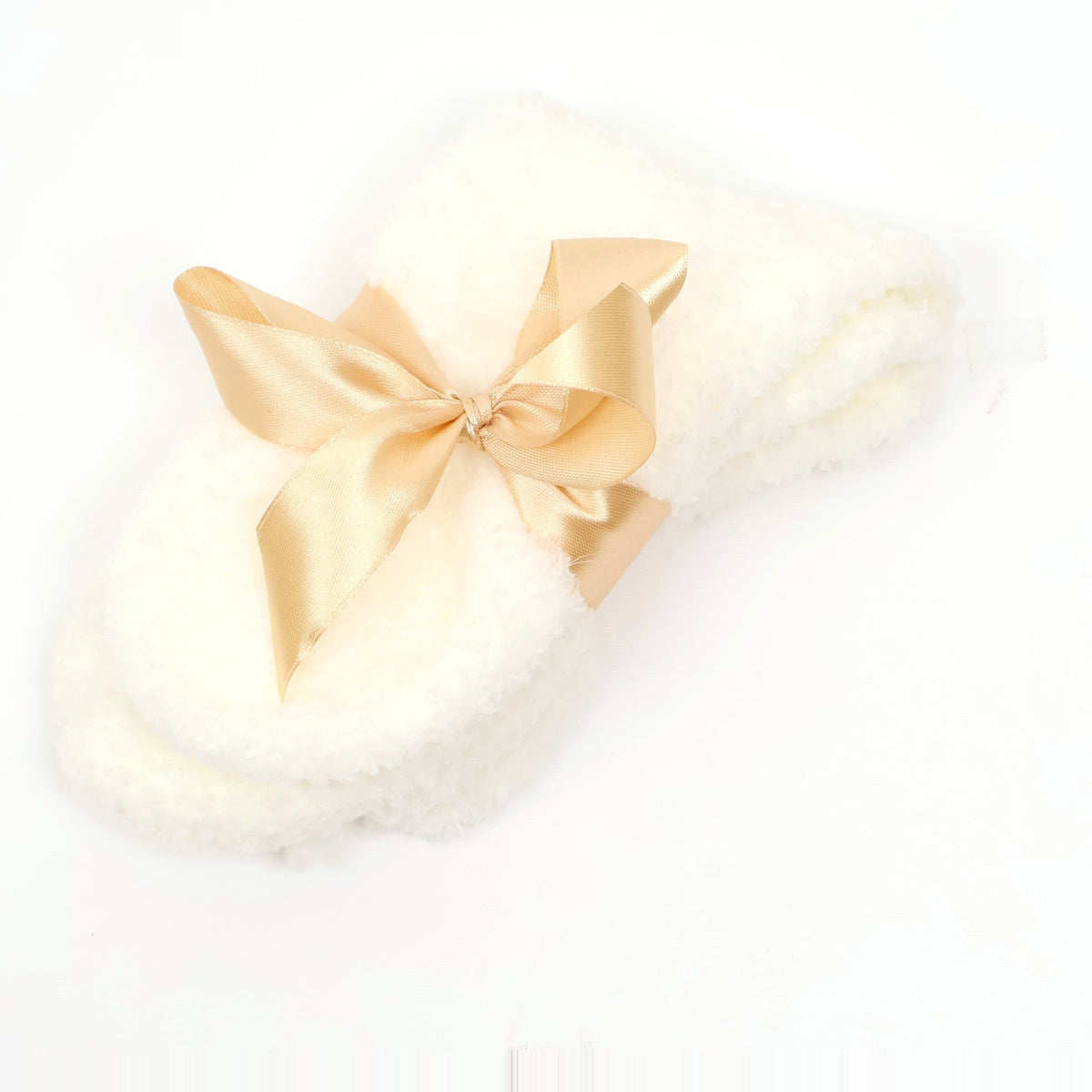 Cream fuzzy socks tied with a gold satin bow
