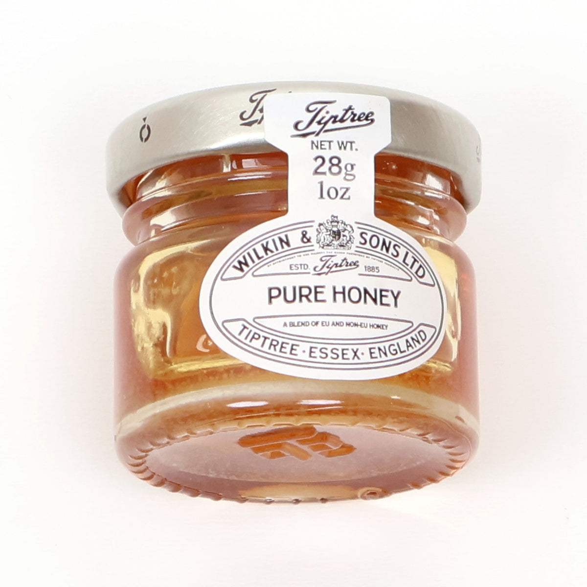 Petite glass jar of pure honey with a silver lid
