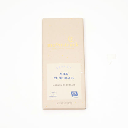 Artisan milk chocolate bar in a cream and gold wrapper