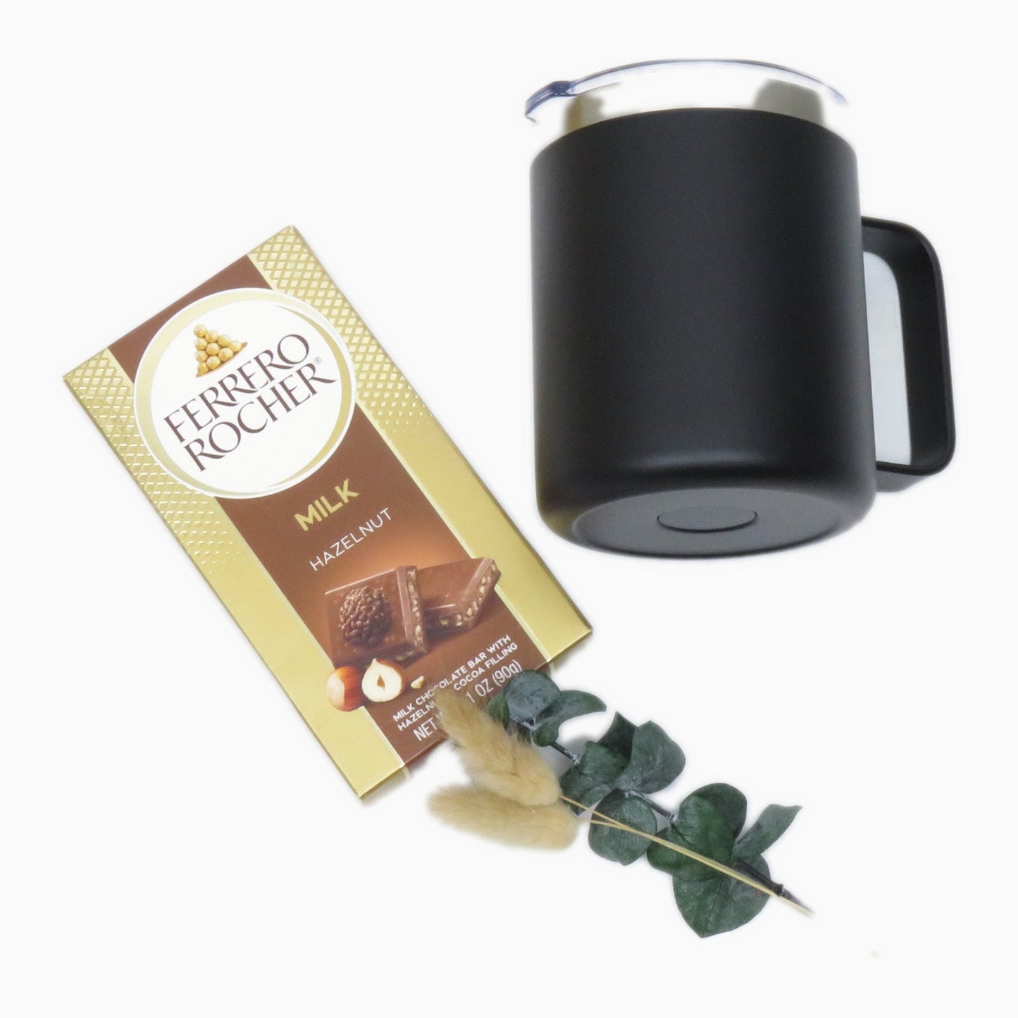 Matte black insulated mug beside a milk chocolate hazelnut bar